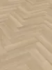 A close-up view of a light-colored wooden floor laid in a herringbone pattern. Produktbild-Vorschau