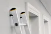 Close-up of a ladder leaning against a textured wall next to a doorway. Podgląd zdjęcia produktu