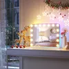 A vanity mirror with lights is displayed on a dresser, decorated for Christmas. Náhled obrázku produktu