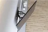 A TV wall mount is attached to a wall, with a TV attached to the mount. The scene is set in a modern living room with wooden flooring. Podgląd zdjęcia produktu