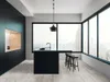 A modern kitchen with a black island and stools, large windows overlooking a city skyline. Produktbild-Vorschau