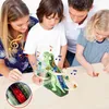 A family is gathered around a table, looking at a dinosaur-themed toy. Náhled obrázku produktu