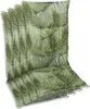 A stack of chair cushions with a green palm leaf pattern on a gray background. Produktbild-Vorschau