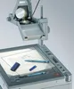 A close-up shot of a projector with a document and pens on its surface. Anteprima dell’immagine prodotto