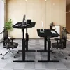 Two adjustable standing desks with chairs in an office setting. Produktbild-Vorschau