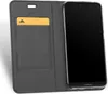 A gray flip case with a slot for a card is shown open, with a smartphone inserted. Produktbild-Vorschau