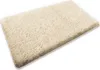 A fluffy beige bath mat is shown from a slightly elevated angle against a white background. Náhled obrázku produktu