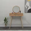 A vanity table with a mirror and makeup accessories, placed in a room with a plant and artwork on the wall. Produktbild-Vorschau