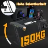 A gaming desk setup with a computer, monitor, keyboard, mouse, headphones, and a cup holder, with promotional text indicating high load capacity. Produktbild-Vorschau