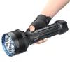 A hand wearing a fingerless glove holds a large, black LED flashlight. Podgląd zdjęcia produktu