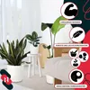 A collection of white plastic plant pots arranged in a home setting with plants. Produktbild-Vorschau