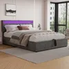 A modern bedroom with a grey upholstered bed featuring LED lighting. Náhled obrázku produktu