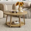A round wooden coffee table with a two-tiered shelf, decorated with sunflowers in a vase, pinecones, and a cup of coffee. Produktbild-Vorschau