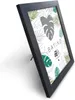 A black picture frame with a botanical print insert, shown at an angle on a white background. Produktbild-Vorschau