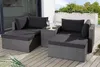 An outdoor lounge set on a wooden deck with plants in the background. Produktbild-Vorschau