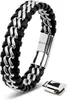 A black leather bracelet with silver metal accents and a silver magnetic clasp, shown on a white background. A separate clasp is shown to the side. Produktbild-Vorschau