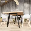 Dining area with a wooden table, white chairs, and a fireplace. Produktbild-Vorschau