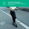 A person riding an electric scooter on a street. Produktbild-Vorschau