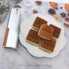 A handheld food printer and decorated cakes are arranged on a table with festive decorations. Podgląd zdjęcia produktu