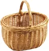 A woven wicker basket with a handle, presented against a white background. Produktbild-Vorschau