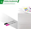 A stack of paper with a color chart on top, and two labels indicating page counts for black and color printing. Produktbild-Vorschau
