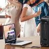 People at a party with a laptop connected to a speaker. Podgląd zdjęcia produktu