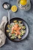 A plate of food with salmon and cauliflower, next to a lemon and a salt dish. Produktbild-Vorschau