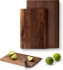 Two wooden cutting boards are shown, one larger and one smaller, with limes and a knife on the smaller board. Náhled obrázku produktu