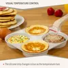 A multi-compartment pan with pancakes and a sausage patty cooking, with a stack of pancakes and an egg in the background. Náhľad obrázku produktu