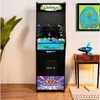 An arcade cabinet is shown in a room with a plant and a small table with a rocket figurine. Náhľad obrázku produktu
