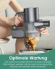 A person is emptying a vacuum cleaner into a bin, demonstrating its maintenance feature. Produktbild-Vorschau