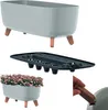 A collage of images showing a planter with legs, a planter insert, and a planter filled with pink flowers. Náhľad obrázku produktu