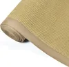A close-up, rolled-up view of a sisal rug with a tan border, set against a white background. Voir les images du produit