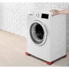 A washing machine is shown on red anti-vibration pads in front of a white brick wall. Produktbild-Vorschau