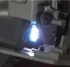 A close-up view of a bright light emanating from a mechanical component, possibly part of a tool or machine. Anteprima dell’immagine prodotto