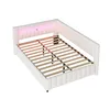 A white upholstered bed frame with a slatted base and LED lighting in the headboard. Podgląd zdjęcia produktu