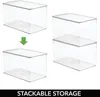 Two clear storage boxes are shown stacked on the right side of the image, demonstrating their stackable nature. On the left, two individual boxes are shown with an arrow indicating they can be stacked. Produktbild-Vorschau