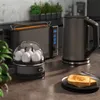 A kitchen counter with a toaster, egg cooker, and kettle. Voir les images du produit