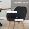 A black velvet armchair with wooden legs is shown in a room setting, next to a wooden table. Náhled obrázku produktu