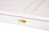 A close-up of a white table with a brass logo. Produktbild-Vorschau