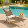 A lounge chair by a swimming pool with drinks on a side table. Produktbild-Vorschau