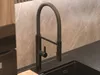 A close-up view of a black kitchen faucet with a pull-out spray. Podgląd zdjęcia produktu