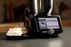 A kitchen appliance is shown next to a plate of desserts. Produktbild-Vorschau