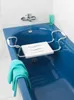 A blue bathtub with a white bath seat installed. Náhled obrázku produktu