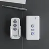 Two remote controls and a pen are placed on a dark gray surface. Produktbild-Vorschau