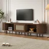 A dark walnut TV stand with rattan accents is shown in a living room setting, with a TV mounted on the wall above it. Podgląd zdjęcia produktu