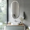 A modern bathroom with a sink, mirror, and decorative elements. Podgląd zdjęcia produktu