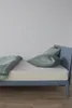 A bed with bedding and pillows. Produktbild-Vorschau