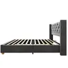 A side view of a gray upholstered bed frame with a tufted headboard and wooden slats. Anteprima dell’immagine prodotto