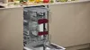 An open dishwasher with its racks extended, showing the interior, set in a kitchen environment. Produktbild-Vorschau